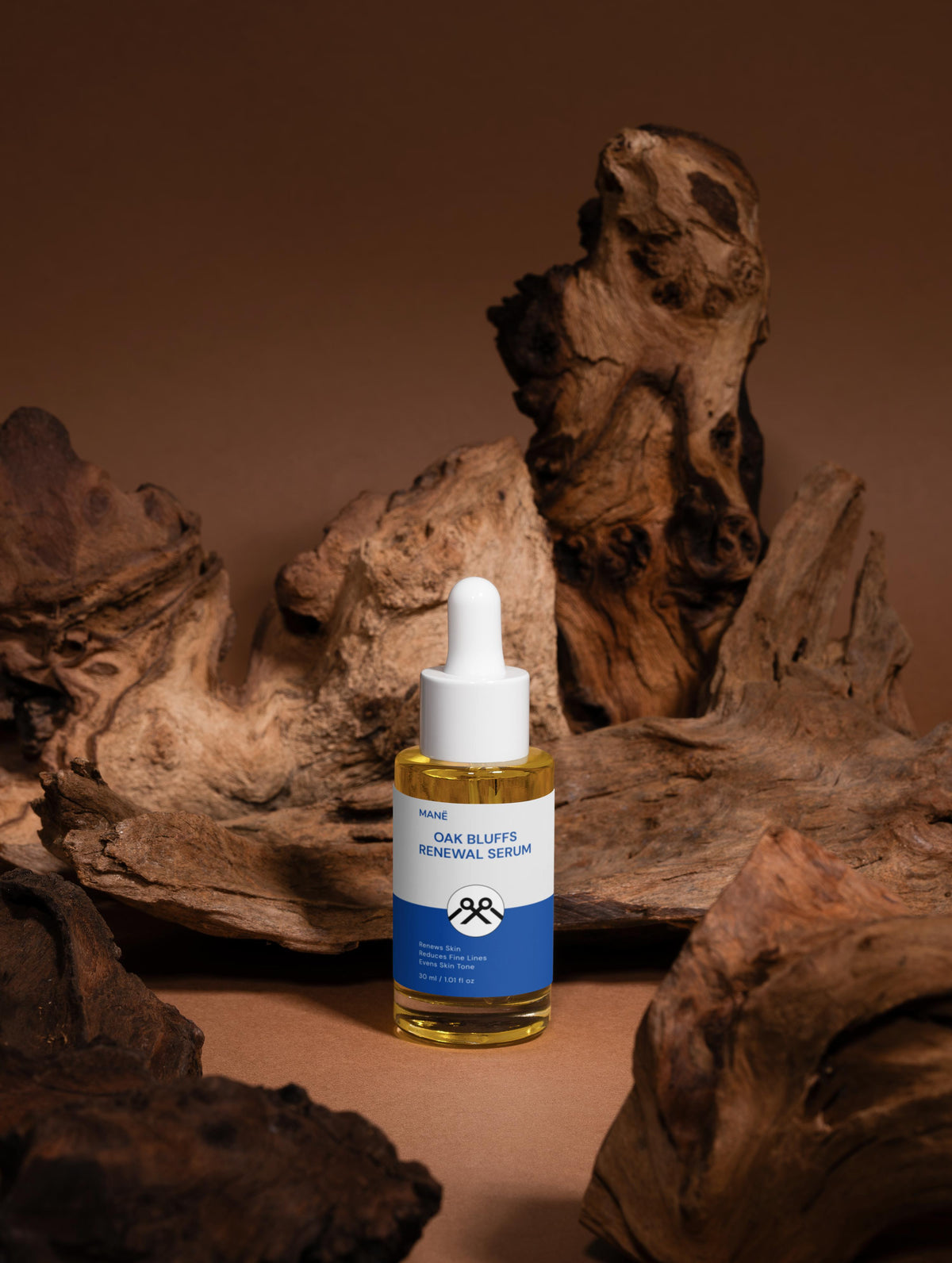 MANË Oak Bluffs Renewal Serum bottle with wood backdrop